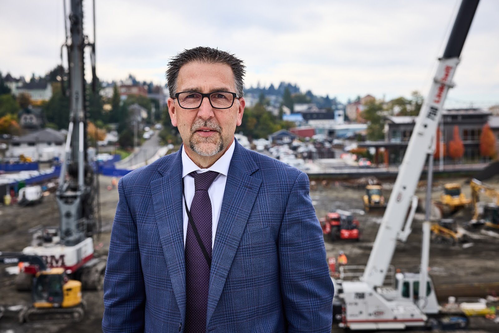 Erik Thorsen, CEO of Columbia Memorial Hospital in Astoria, Ore., stands on the hospital roof overlooking the construction. The project, designed to fortify the building in the event of an earthquake and provide shelter during a tsunami, is proceeding — even without funds promised from the federal government.